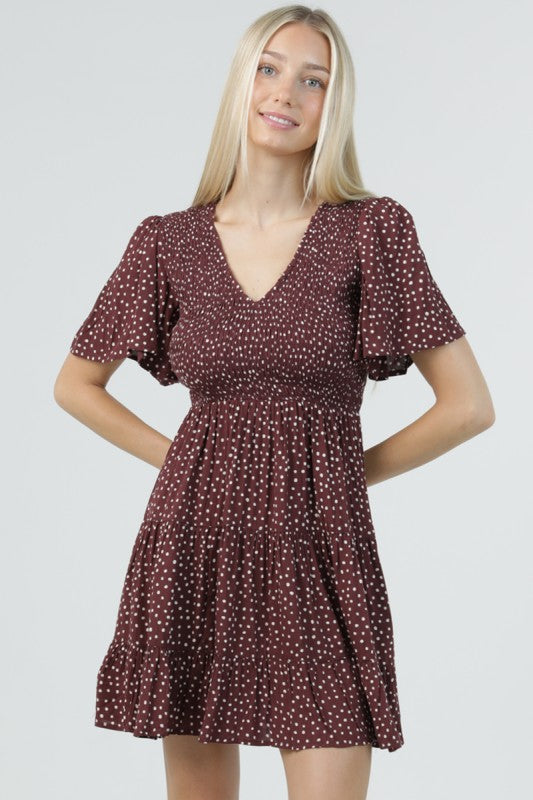 Chocolate brown dotted short dress with V-neckline, flutter sleeves and tiered skirt