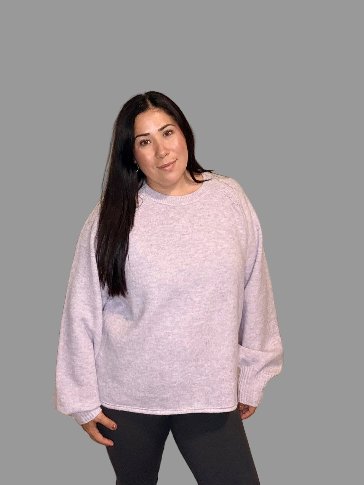 Model wearing light lavender long-sleeve sweater with round neckline